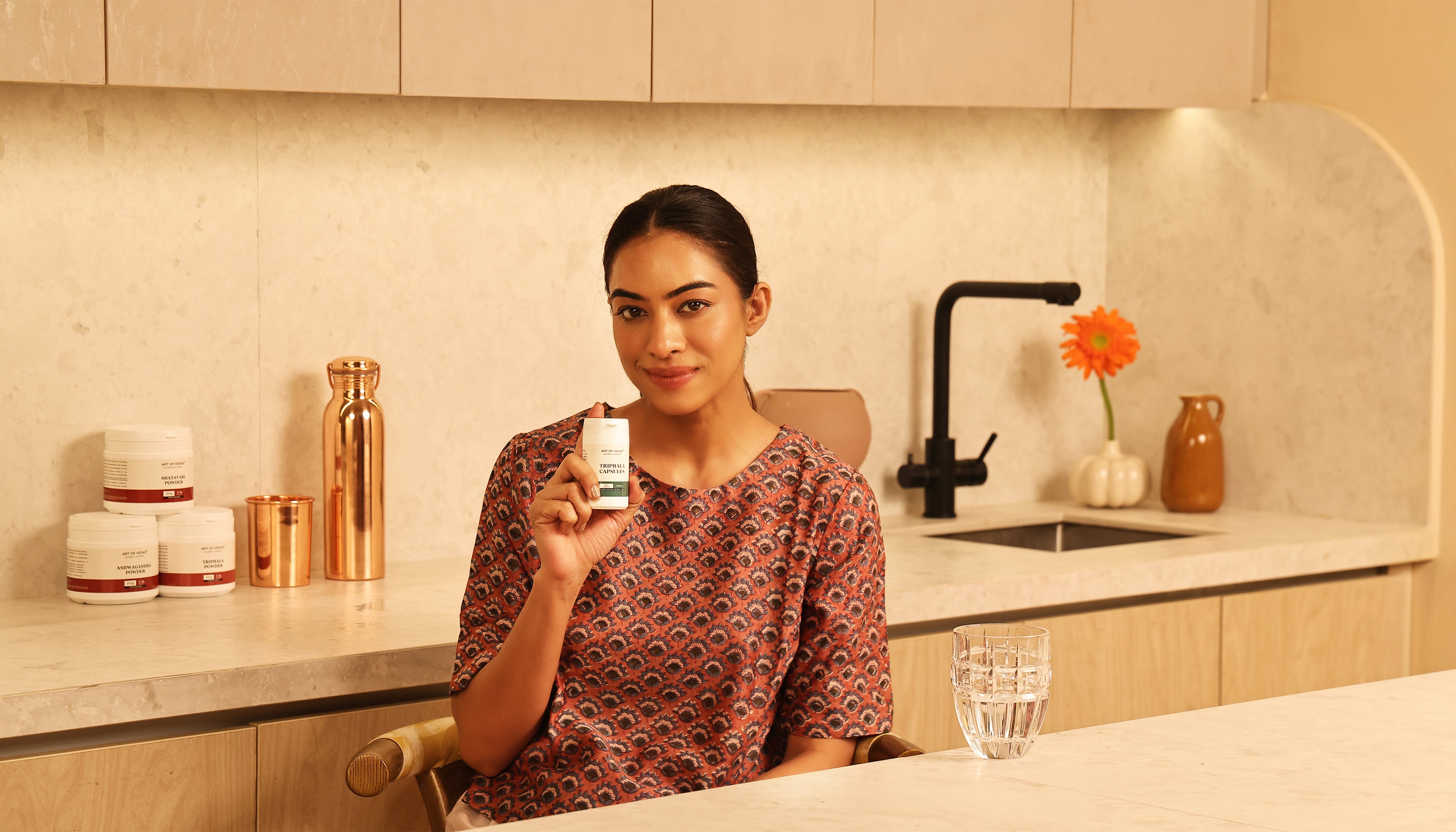 Art of Vedas Ayurveda Supplements - Woman Holding Ayurvedic Herbal Supplement Bottle for Natural Wellness and Health